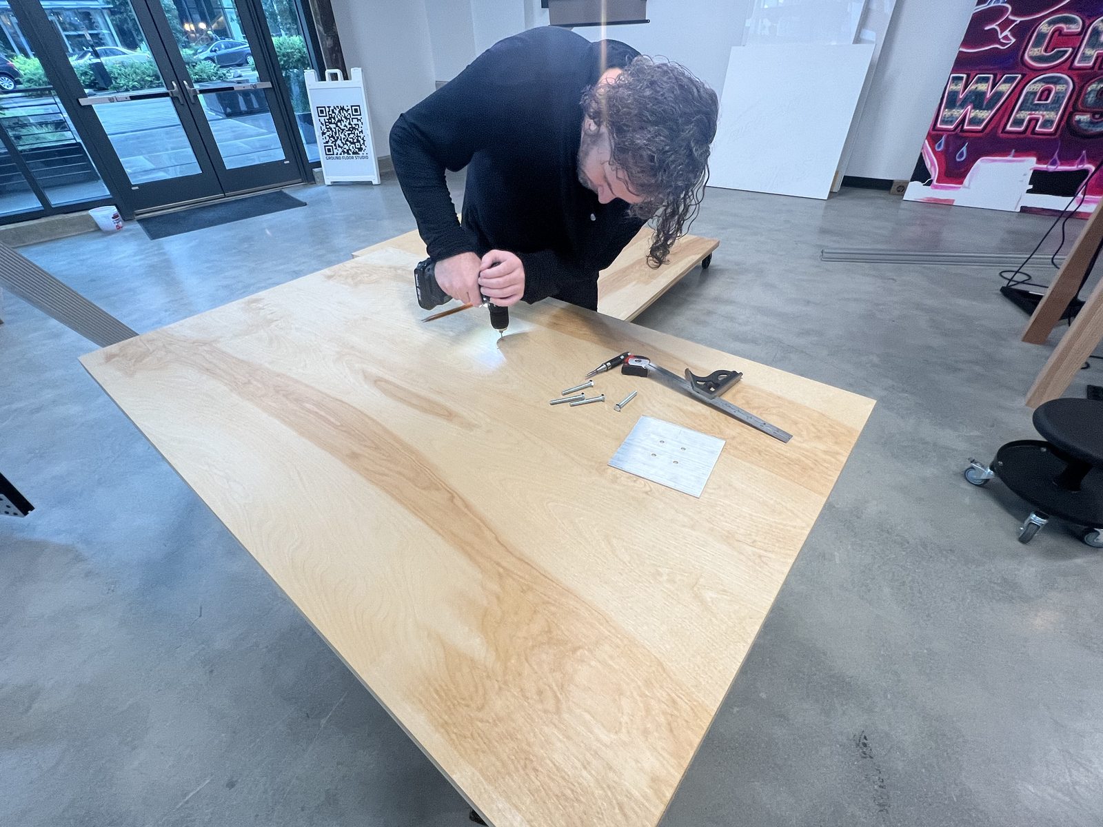 Joshua aligning the aluminium extrusion mast on a solid-core door cart base
