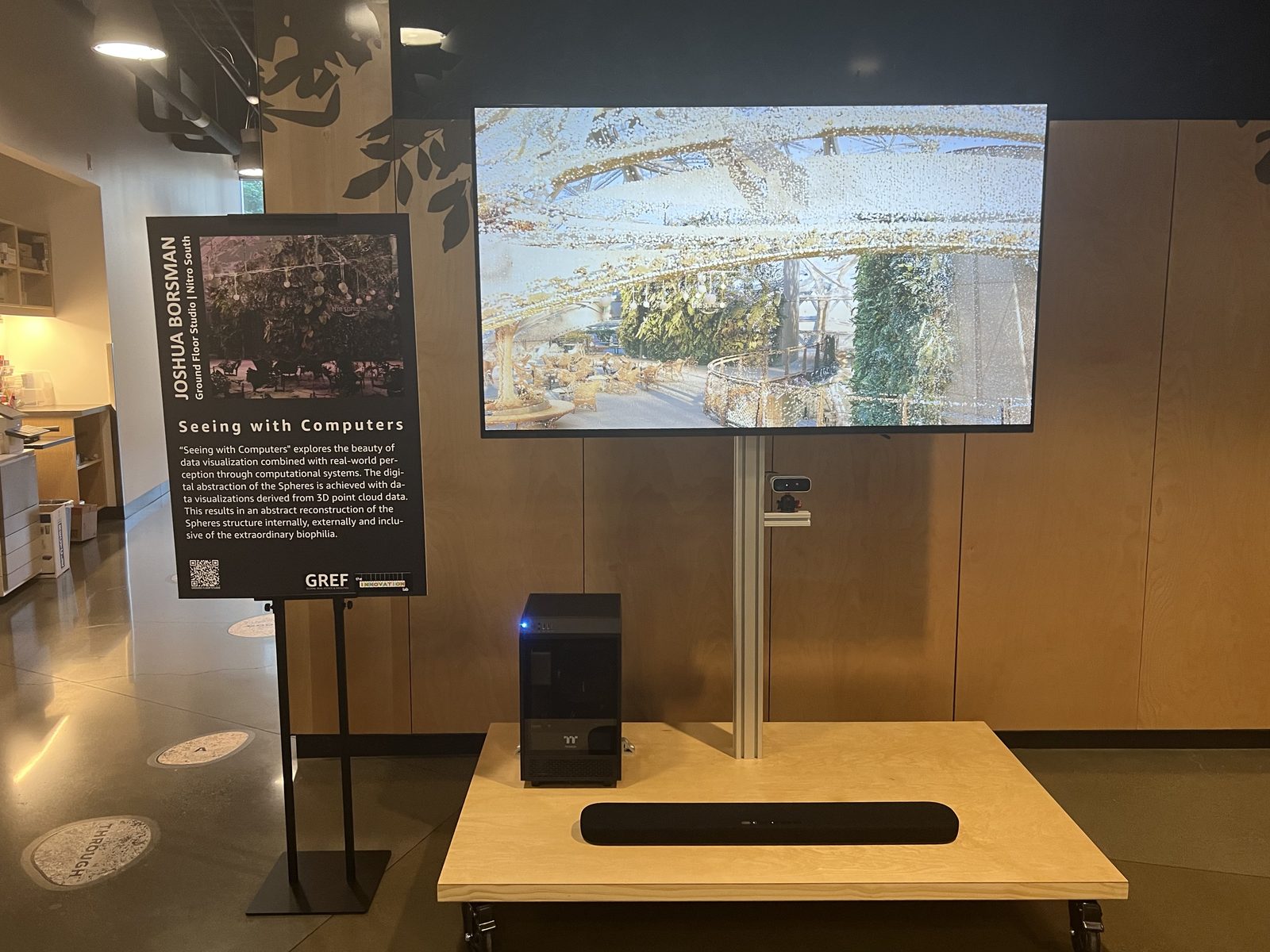 The installed exhibit on campus, beside an A-frame placard reading 'Joshua Borsman — Seeing with Computers'