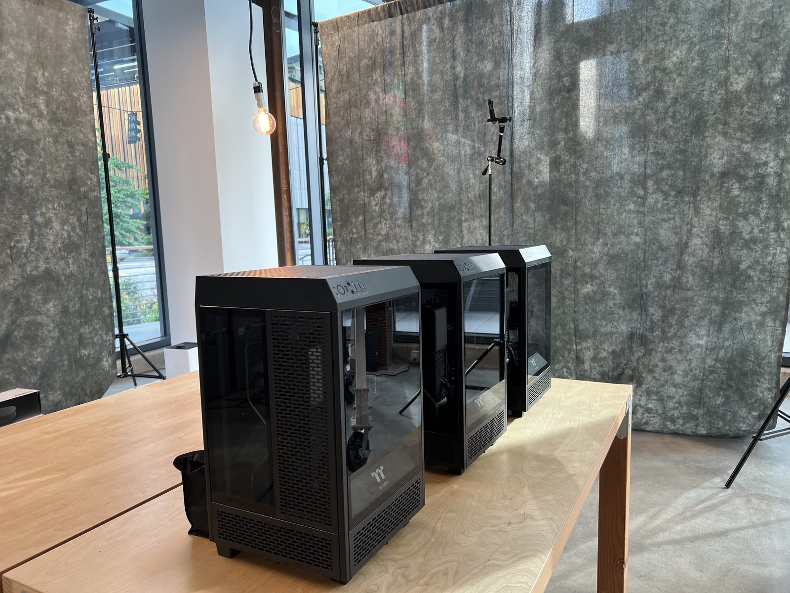 Three completed PC towers on a workbench in the studio