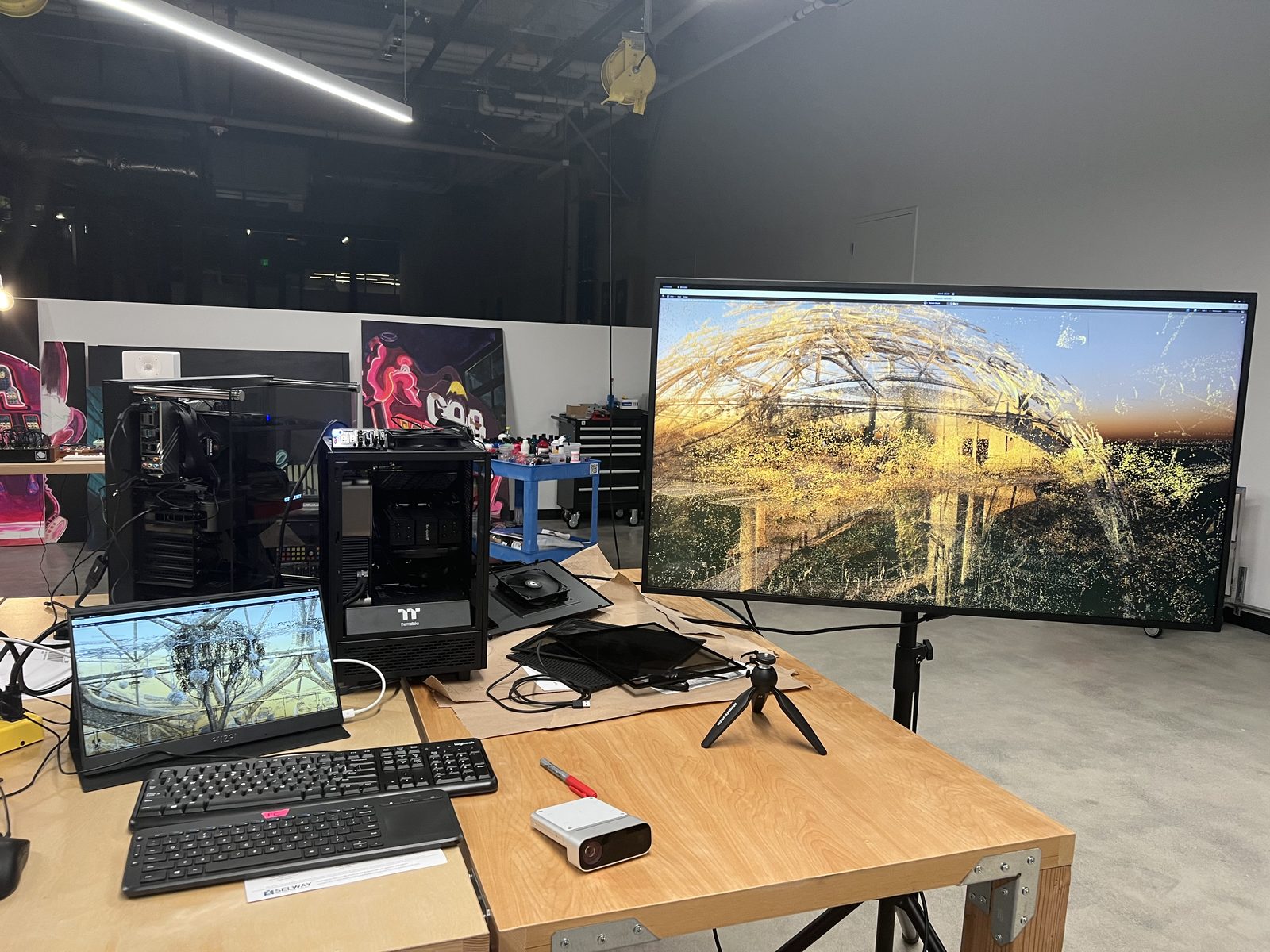 Test station in studio — Azure Kinect depth sensor on a tripod, paired with custom PC and a monitor running the point-cloud render of the Spheres